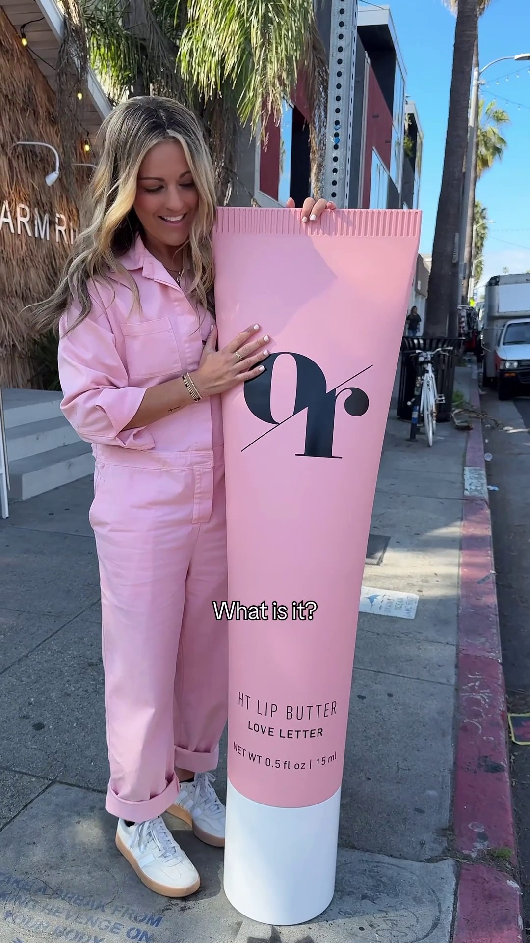 Two women pushing HT SERUM CONCEALER on cart at crosswalk; sign DS&D URGA; Do you need help? NET WT 0.17 fl oz 5 ml