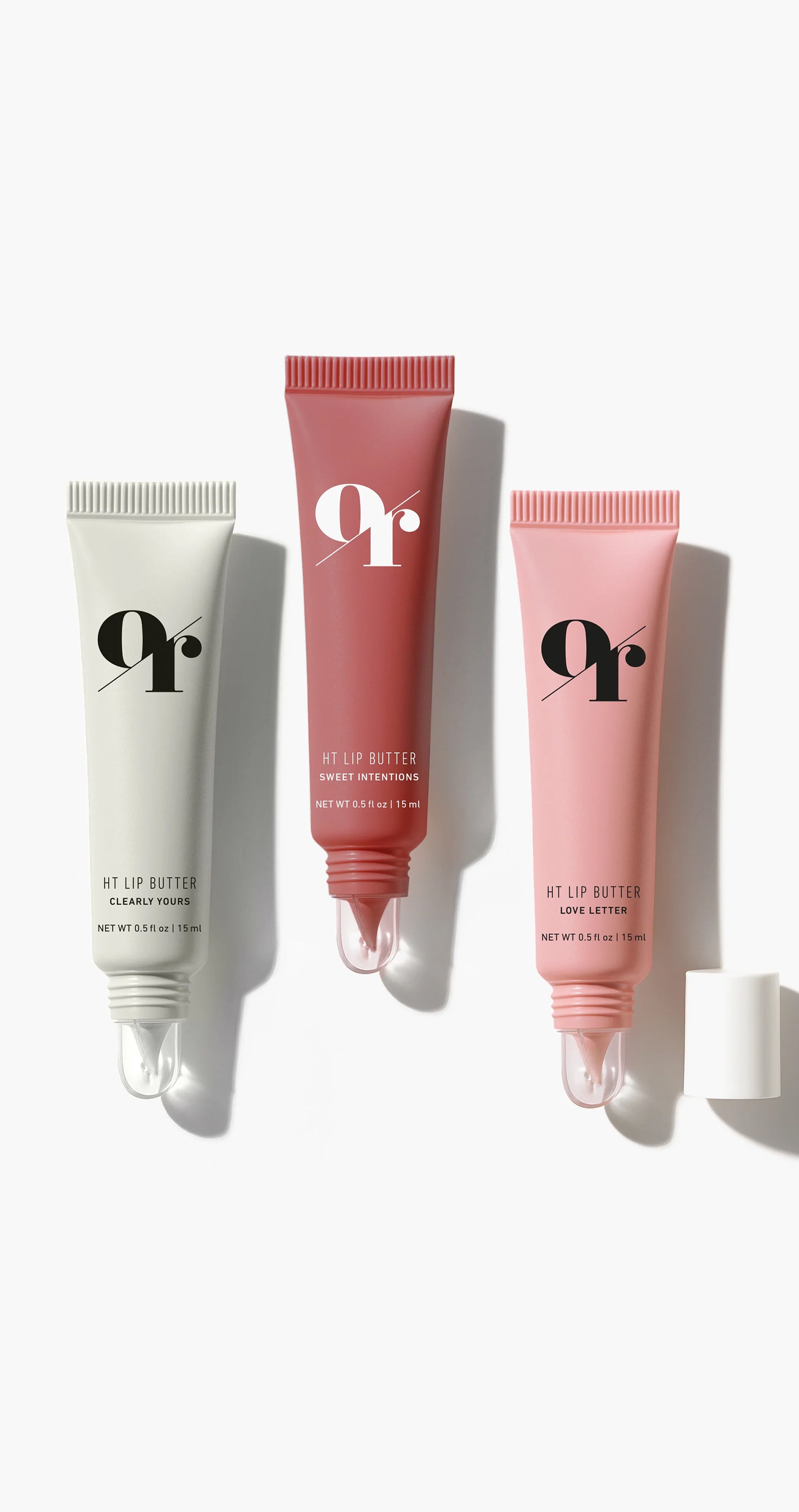 Three HT Lip Butter tubes from Love Story Set (Clearly Yours; Sweet Intentions; Love Letter) showing clear silicone applicators on white background