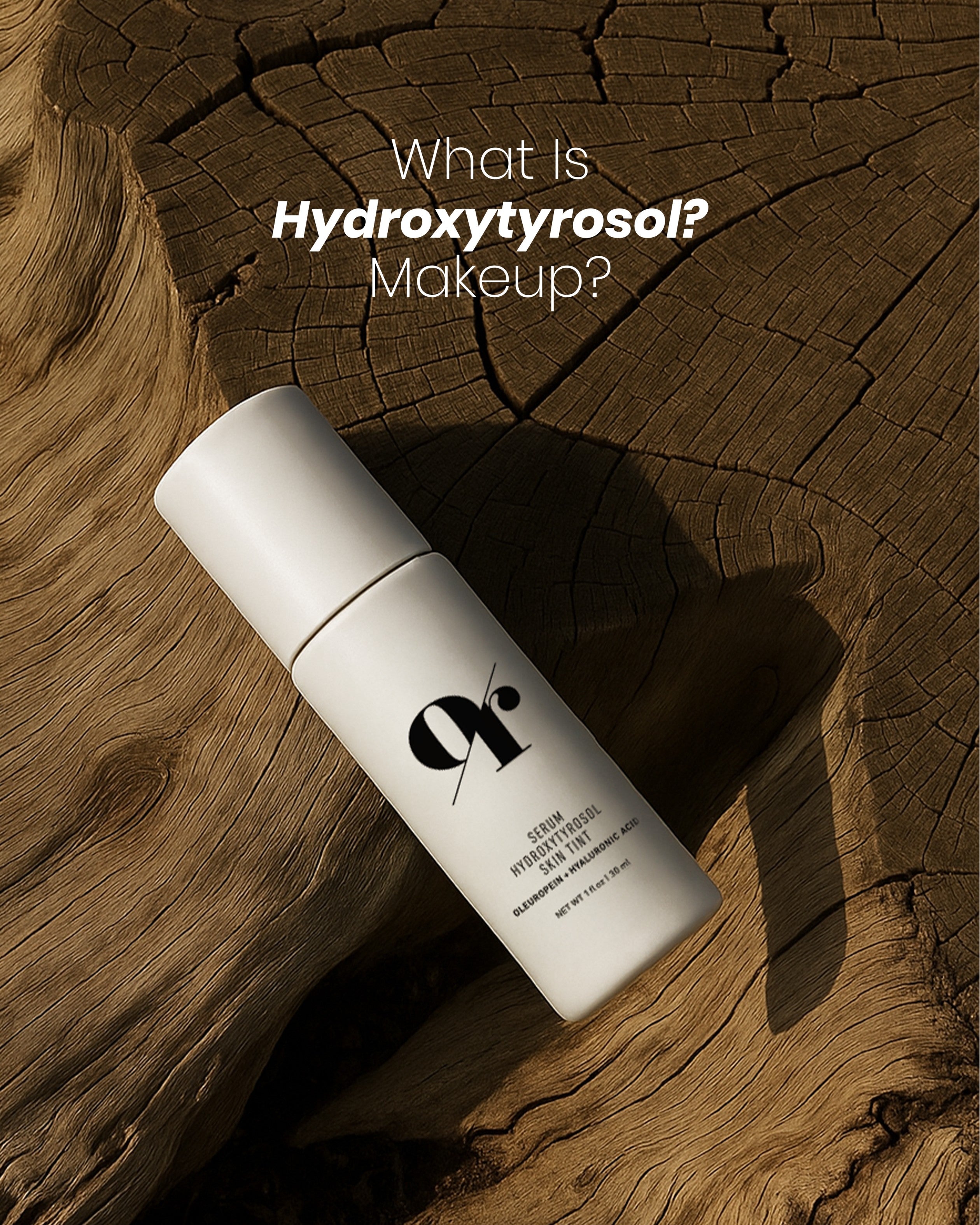 Angled bottle of 9r Serum Hydroxytyrosol skin tint with logo on wood background and overlaid text What Is Hydroxytyrosol? Makeup?
