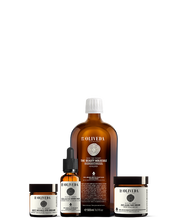 Load image into Gallery viewer, Front view of OLIVEDA Facial Glow Starter Set with large amber bottle, dropper serum, and two cream jars