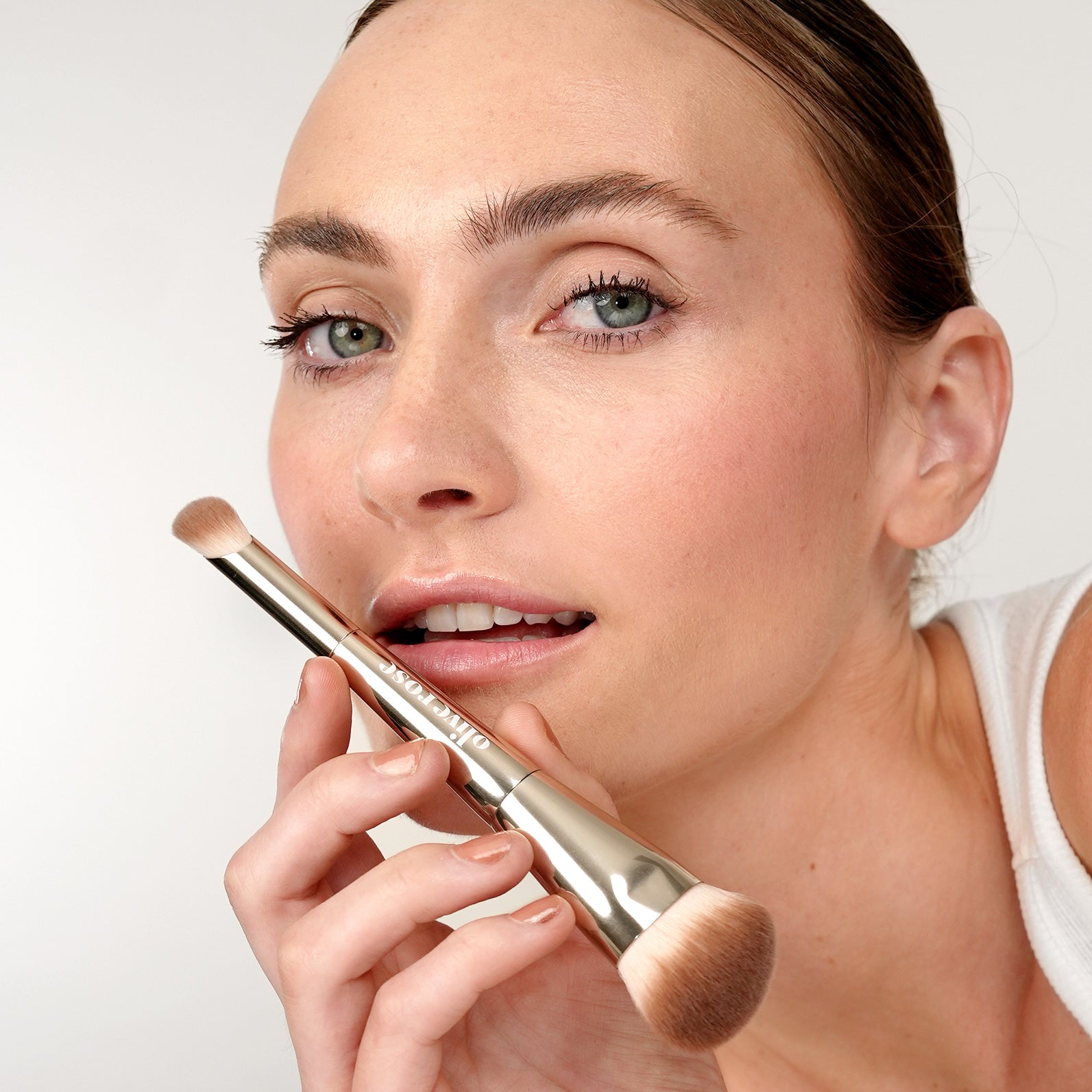 Woman holding an Olive Rose brush