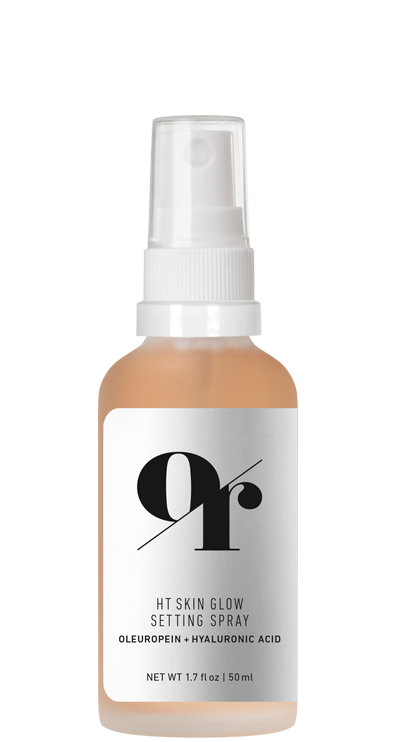 Front view of HT Skin Glow Setting Spray bottle showcasing peach-tinted liquid and label reading oleuropein + hyaluronic acid, 1.7 fl oz on white background