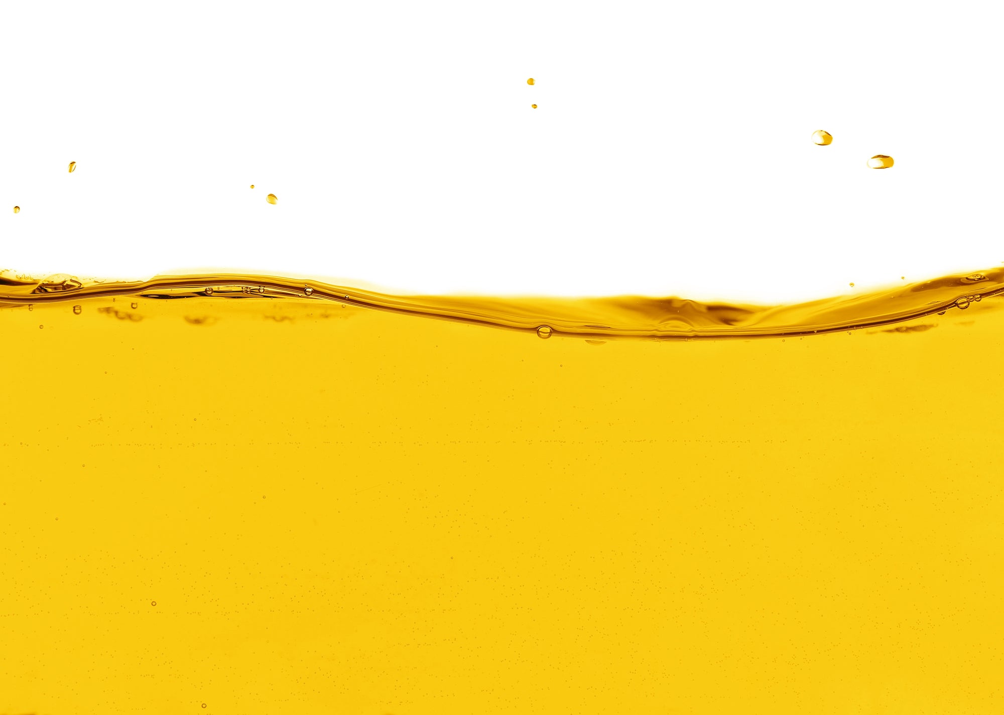 Golden oil wave with small droplets against a white background